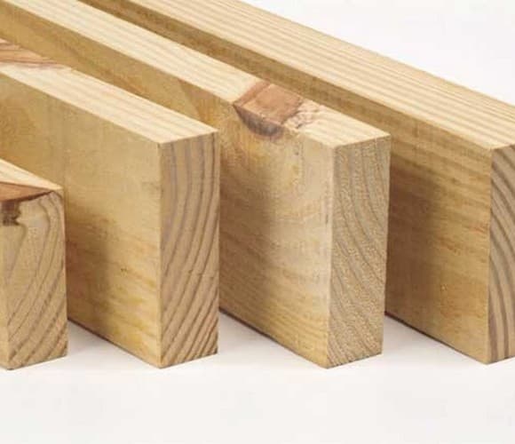 Stacked light Melina (Gmelina) wood, ready for carpentry and sustainable construction projects.