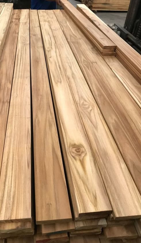 High quality Teak (Tectona Grandis) wood planks, showing its golden grain and texture.
